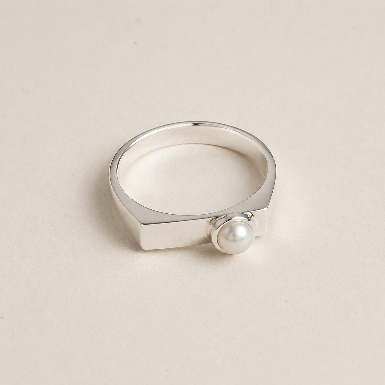Slim silver signet ring with button pearl cabochon